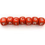 Row of red cubes bearing white letters spell 'SUCCESS' and 'FAILURE', laid in a line for outcomes.
