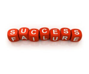 Row of red cubes bearing white letters spell 'SUCCESS' and 'FAILURE', laid in a line for outcomes.